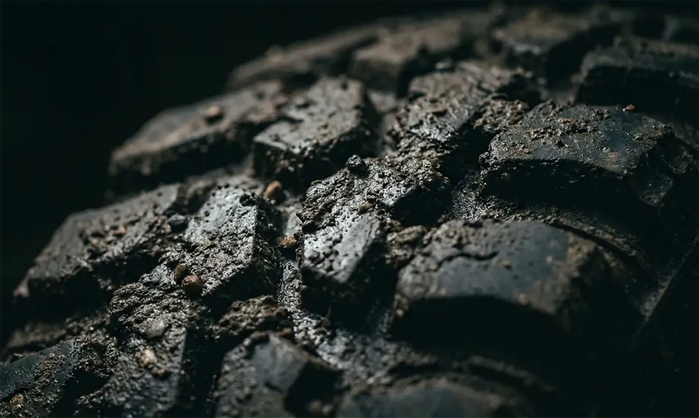 HT vs. AT vs. MT Tires: Which Is Right for You? 3 Mud-terrain tire lugs with mud caked in voids