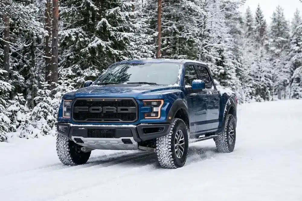 AT vs RT Tires: What Is Rugged Terrain? 8 F-150 with all-terrain tires driving through fresh snow